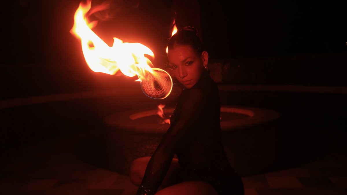 Flames of Passion Entertainment: a fire performer spinning fire poi